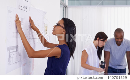 Woman, architect and planning with board of documents or paperwork in meeting for architectural design at office. Female person, contractor or designer with team for floor plan or ideas at workplace Woman, architect and planning with board of documents or paperwork in meeting for architectural design at office. Female person, contractor or designer with team for floor plan or ideas at workplace 140701839