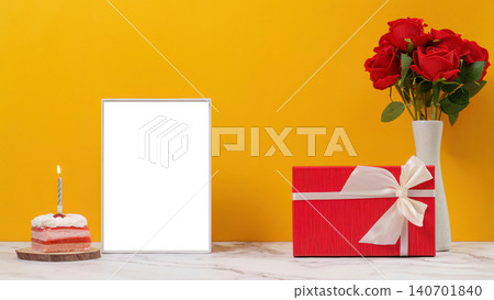 Birthday mockup with blank frame lit candle cake and gift box on yellow background Birthday mockup with blank frame lit candle cake and gift box on yellow background 140701840