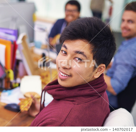 Businessman, portrait and eating with smile in office for lunch break, pizza and coworking company. Programmer, asian employee and face or happiness with fast food, coding team and working at desk Businessman, portrait and eating with smile in office for lunch break, pizza and coworking company. Programmer, asian employee and face or happiness with fast food, coding team and working at desk 140702017
