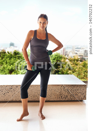 Portrait, dumbbell and woman outdoor to exercise for training, workout or power on balcony for wellness. Strong, female person and weightlifting for fitness, sports or bodybuilding for healthy muscle Portrait, dumbbell and woman outdoor to exercise for training, workout or power on balcony for wellness. Strong, female person and weightlifting for fitness, sports or bodybuilding for healthy muscle 140702252