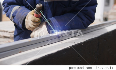 Closeup Fabricator Using Welding Torch On Metal Frame, Sparks And Heat At Joint, Gloved Hands Steadying Fixture, Workshop And Onsite Assembly Combined In Practical Fabrication Scene Closeup Fabricator Using Welding Torch On Metal Frame, Sparks And Heat At Joint, Gloved Hands Steadying Fixture, Workshop And Onsite Assembly Combined In Practical Fabrication Scene 140702914