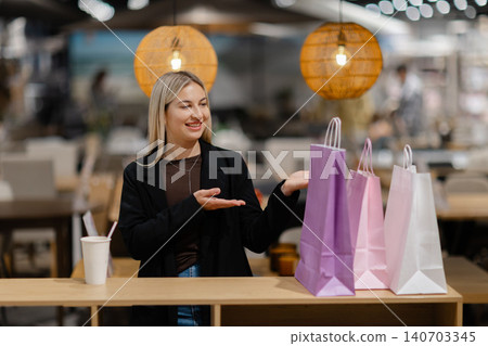 Woman presenting shopping bags showing customer satisfaction 140703345