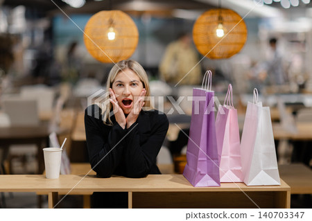 Surprised woman enjoying her retail therapy shopping experience 140703347