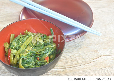 stir fried slice Chinese morning glory with chili in soybean paste on bowl with chopsticks stir fried slice Chinese morning glory with chili in soybean paste on bowl with chopsticks 140704035