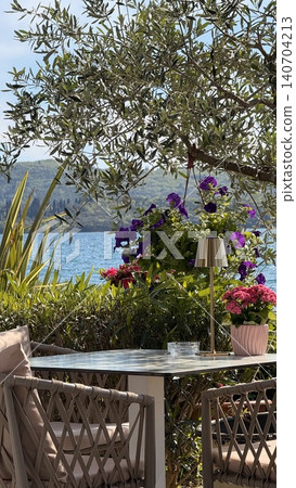 Seaside terrace with blooming flowers Seaside terrace with blooming flowers 140704213