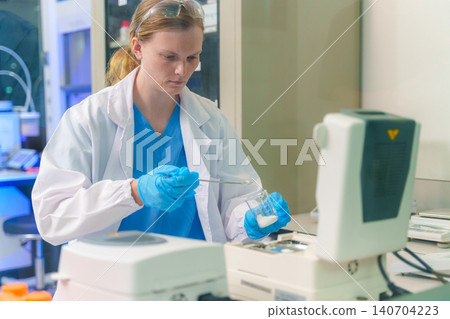 Scientist conducting research in a modern laboratory with advanced technology and equipment for scientific studies Scientist conducting research in a modern laboratory with advanced technology and equipment for scientific studies 140704223