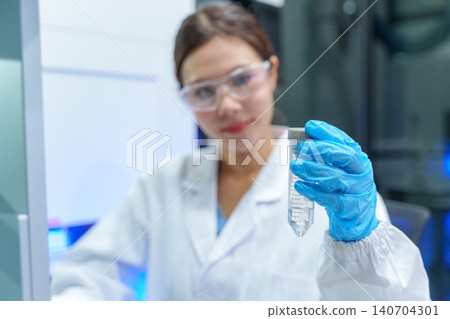 Scientist analyzing sample in laboratory setting using modern technology and equipment for research and development Scientist analyzing sample in laboratory setting using modern technology and equipment for research and development 140704301