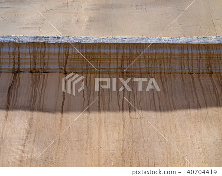 Abstract geometry of a centered building cornice with contrast sunlight and shadow Abstract geometry of a centered building cornice with contrast sunlight and shadow 140704419