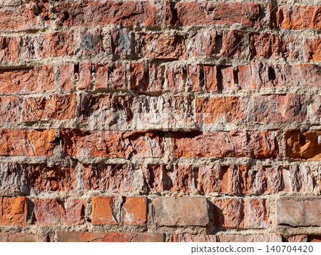 Ancient ruined red brick wall texture fragment on a historic building facade Ancient ruined red brick wall texture fragment on a historic building facade 140704420