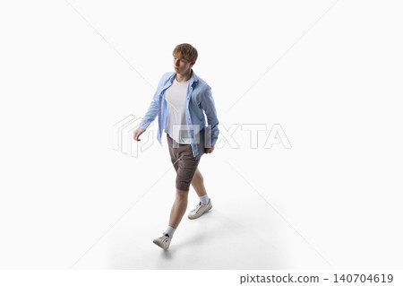 Teenage boy walking in white casual clothes isolated on white background. Teenage boy walking in white casual clothes isolated on white background. 140704619