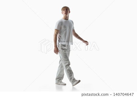 Teen boy walking in white casual outfit on isolated background. Teen boy walking in white casual outfit on isolated background. 140704647