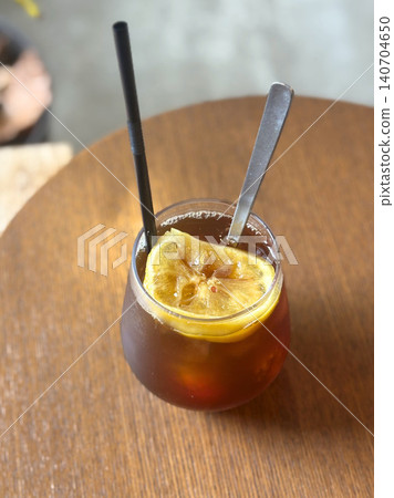 A moment at the cafe with an iced coffee topped with lemon. A moment at the cafe with an iced coffee topped with lemon. 140704650