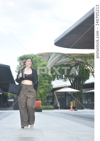 business woman walking in community mall garden 140705213