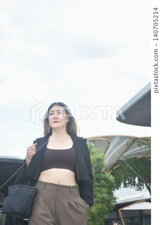 business woman walking in community mall garden business woman walking in community mall garden 140705214