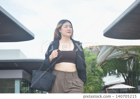 business woman walking in community mall garden business woman walking in community mall garden 140705215