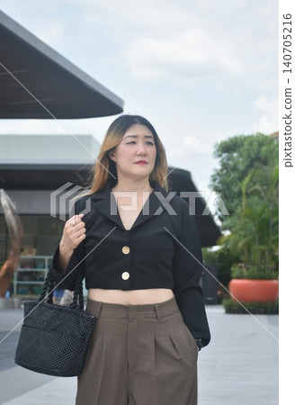 business woman walking in community mall garden business woman walking in community mall garden 140705216