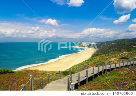 The wooden stairway at the rocky seashore on a sunny day. Polvoeira the beach. Pataias, Portugal, Europe The wooden stairway at the rocky seashore on a sunny day. Polvoeira the beach. Pataias, Portugal, Europe 140705960