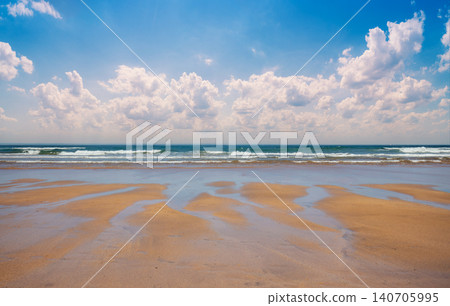 Sandy beach at low tide. Ocean on a sunny day Sandy beach at low tide. Ocean on a sunny day 140705995