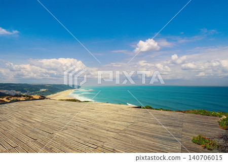The wooden platform for paragliding flight. Rocky seashore in sunny day. Victory Walls Beach (Praia de Paredes da Vitoria). Pataias, Portugal, Europe The wooden platform for paragliding flight. Rocky seashore in sunny day. Victory Walls Beach (Praia de Paredes da Vitoria). Pataias, Portugal, Europe 140706015