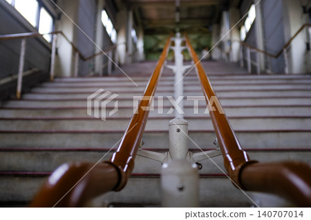 Close-up of the concrete stairs. Long stair railings in the station of Sapporo, Hokkaido, Japan. Cityscape and travel concept. Close-up of the concrete stairs. Long stair railings in the station of Sapporo, Hokkaido, Japan. Cityscape and travel concept. 140707014