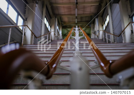 Close-up of the concrete stairs. Long stair railings in the station of Sapporo, Hokkaido, Japan. Cityscape and travel concept. Close-up of the concrete stairs. Long stair railings in the station of Sapporo, Hokkaido, Japan. Cityscape and travel concept. 140707015