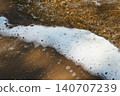 Sea wave foam on wet sand at high tide. 140707239