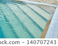 Pool steps beneath clear blue water.  140707243