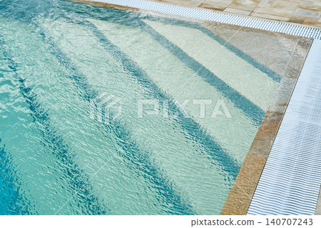 Pool steps beneath clear blue water. Pool steps beneath clear blue water. 140707243