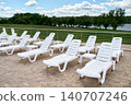 White lounge chairs on the resort terrace with a picturesque view of the lake. 140707246