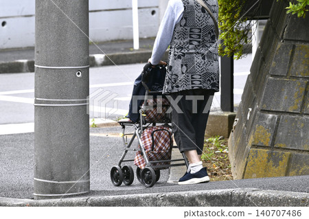 Steps in the urban landscape of Yokohama, Japan... Elderly woman using a mobility scooter... Stools are popular... Aging society... = 23rd Steps in the urban landscape of Yokohama, Japan... Elderly woman using a mobility scooter... Stools are popular... Aging society... = 23rd 140707486