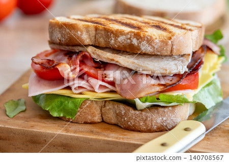 Close Up of Club Sandwich with Bacon, Ham, Cheese and Grilled Chicken Close Up of Club Sandwich with Bacon, Ham, Cheese and Grilled Chicken 140708567