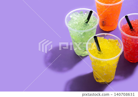 Colorful Frozen Slush Drinks in Plastic Cups Colorful Frozen Slush Drinks in Plastic Cups 140708631