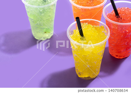 Colorful Frozen Slush Drinks in Plastic Cups Colorful Frozen Slush Drinks in Plastic Cups 140708634