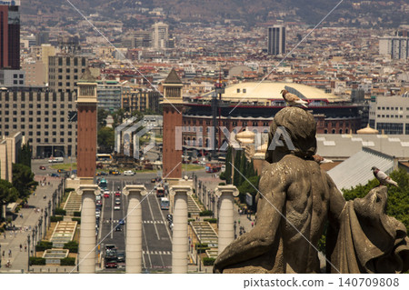 Stone sculpture and pigeons overlooking barcelona cityscape 140709808