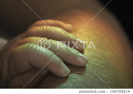 Baby hand connecting with adult skin, showing family love 140709814