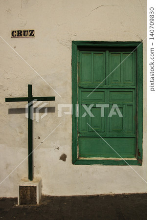 Cruz sign and green window shutters on old wall Cruz sign and green window shutters on old wall 140709830