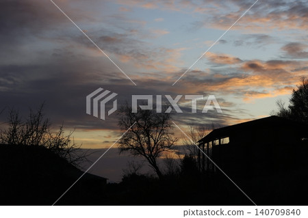 Rural landscape with trees and house silhouettes at sunset Rural landscape with trees and house silhouettes at sunset 140709840