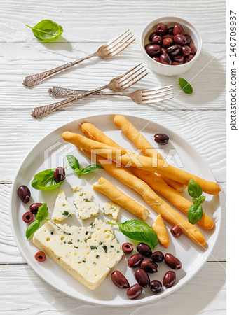 Premium blue cheese plate with grissini and olives Premium blue cheese plate with grissini and olives 140709937