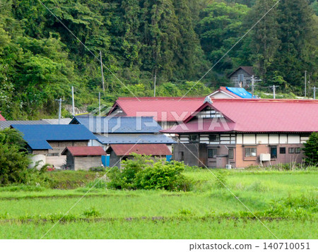 A quiet mountain village in Gonohe Town, Aomori Prefecture; rice paddies stretch out in front of the village. A quiet mountain village in Gonohe Town, Aomori Prefecture; rice paddies stretch out in front of the village. 140710051