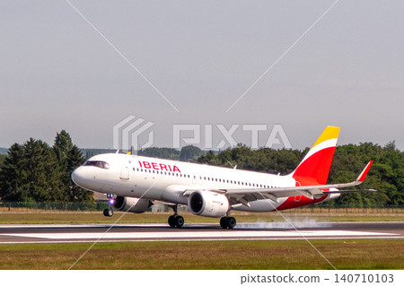 Iberia Airbus A320neo airplane landing on a runway Iberia Airbus A320neo airplane landing on a runway 140710103