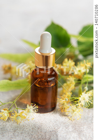 Linden essential oil in dropper bottle with fresh flowers Linden essential oil in dropper bottle with fresh flowers 140710286