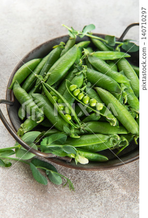 Fresh green peas in rustic bowl healthy food concept Fresh green peas in rustic bowl healthy food concept 140710297