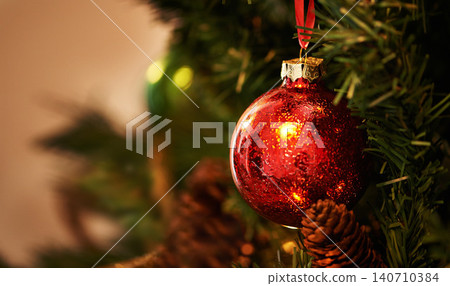 Christmas, tree and red ornament for holiday, celebration and closeup with tradition or festive season at home. Decorations, detail and event with glitter ball, circle or sphere for xmas background 140710384