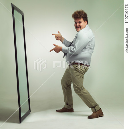 Mirror, portrait and man with smile pointing, double chin and happiness for reflection in studio. Overweight, plus size and male person with obesity, comic and excited to change unhealthy life Mirror, portrait and man with smile pointing, double chin and happiness for reflection in studio. Overweight, plus size and male person with obesity, comic and excited to change unhealthy life 140710478