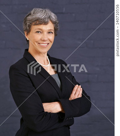Senior woman, arms crossed in portrait and corporate professional with smile, pride and job satisfaction on wall background. Manager, confident and realtor in London with ambition and happy in career Senior woman, arms crossed in portrait and corporate professional with smile, pride and job satisfaction on wall background. Manager, confident and realtor in London with ambition and happy in career 140710556