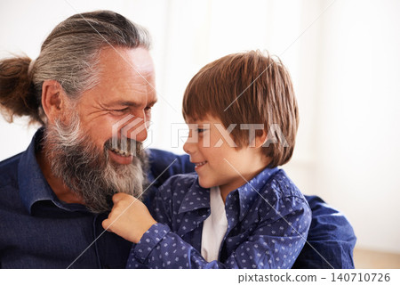 Smile, grandfather and boy with beard and playing, bonding and relax in living room. Happy family, play and fun with grandpa and pulling facial hair, embrace and caring cuddle with love in lounge 140710726