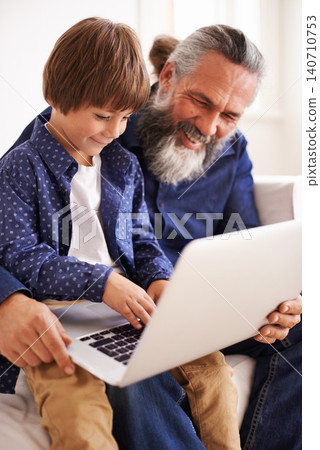 Grandfather, laptop and boy child for streaming, elearning and bonding in living room. Focus, family and internet for play and son typing, childhood development and games or technology for learning Grandfather, laptop and boy child for streaming, elearning and bonding in living room. Focus, family and internet for play and son typing, childhood development and games or technology for learning 140710753