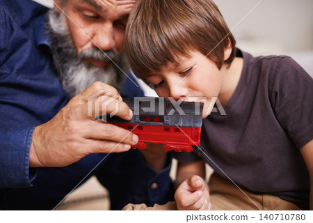 Grandfather, toy and train with boy child, playing and bonding in family home. Grandpa, young kid and childhood development with games and fun, quality time and love with senior retired man Grandfather, toy and train with boy child, playing and bonding in family home. Grandpa, young kid and childhood development with games and fun, quality time and love with senior retired man 140710780