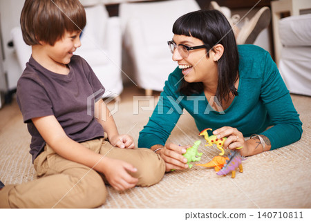 Mother, kid and toy with dinosaur, floor and play for joy or fun at family home or house. Woman, child and bedroom with bonding, childhood and future development or growth for happy care together Mother, kid and toy with dinosaur, floor and play for joy or fun at family home or house. Woman, child and bedroom with bonding, childhood and future development or growth for happy care together 140710811