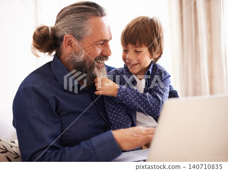 Smile, boy child and grandfather with beard and laptop, bonding and relax in living room. Happy family, play and fun with grandpa and pulling face hair, elearning and online with computer for learn Smile, boy child and grandfather with beard and laptop, bonding and relax in living room. Happy family, play and fun with grandpa and pulling face hair, elearning and online with computer for learn 140710835